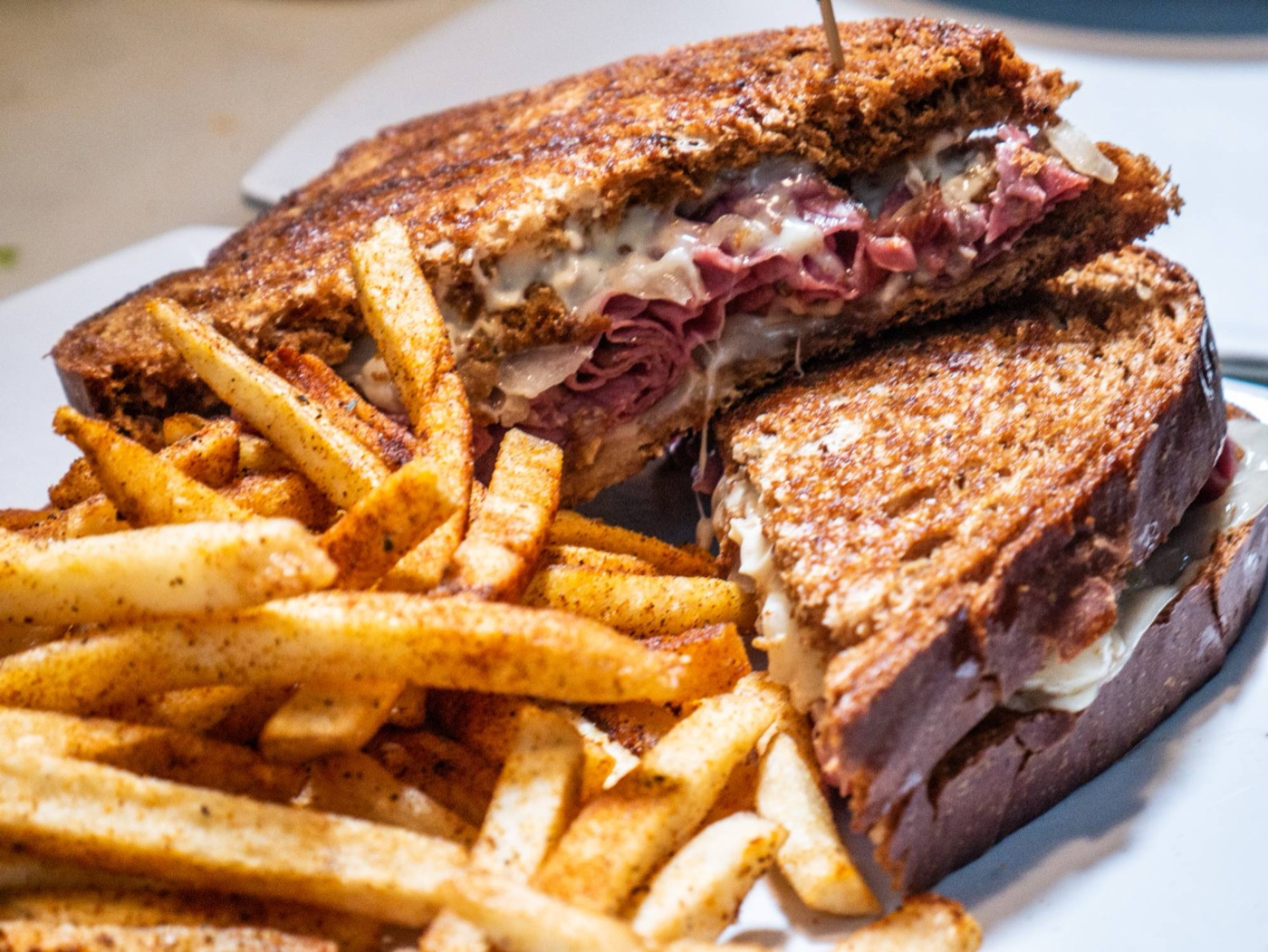 Reuben on grilled rye with Cajun fries